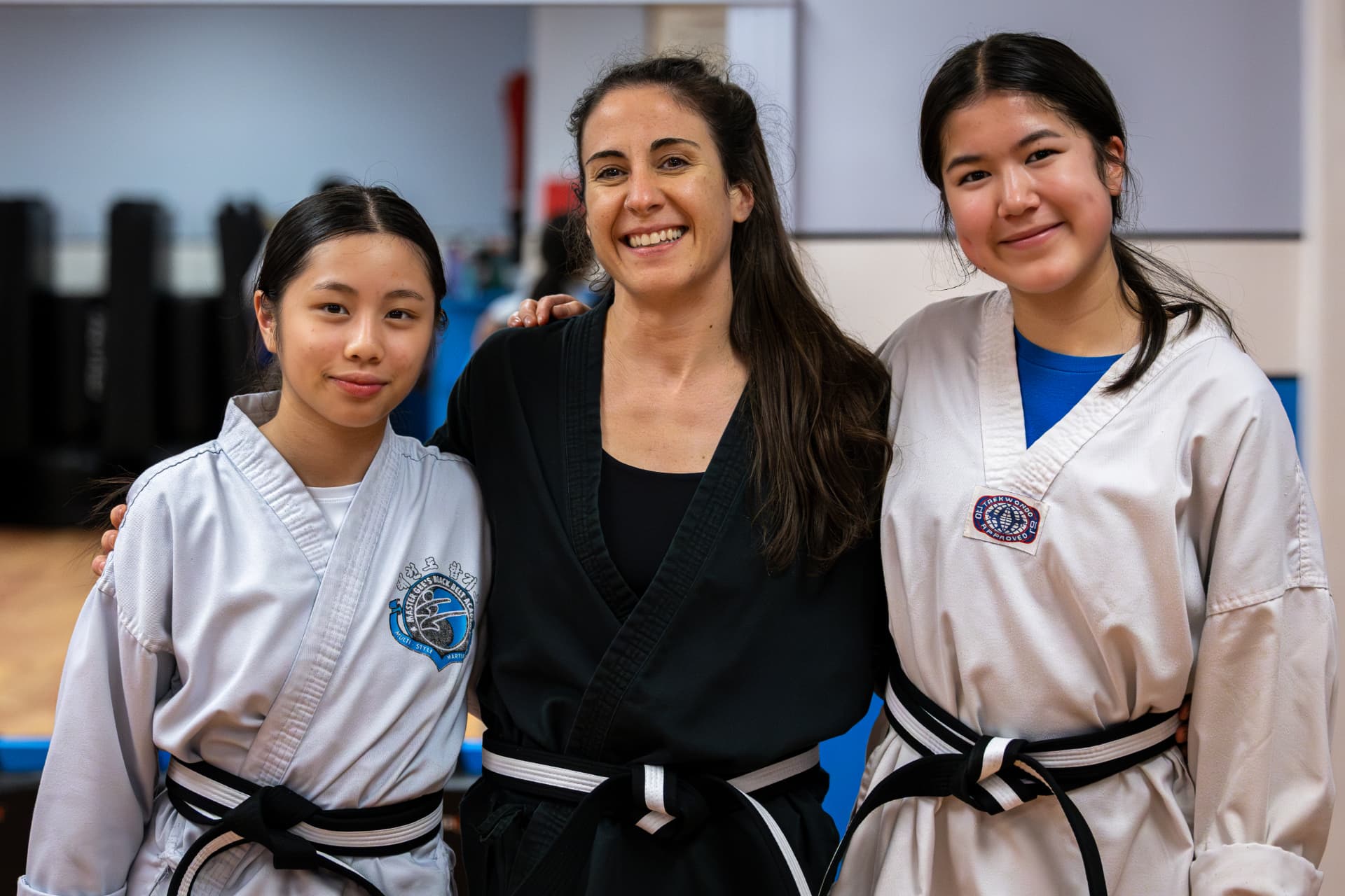 Instructor with two black belt students