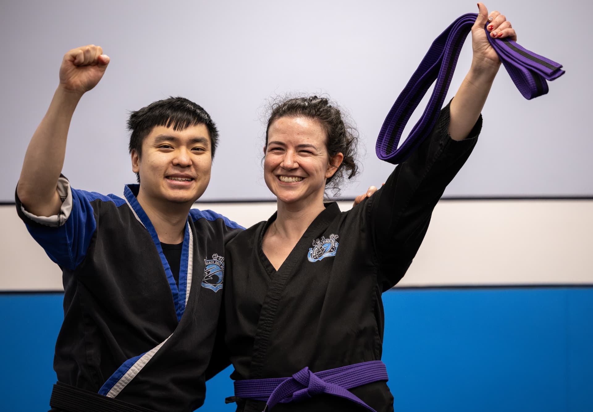 Adult students celebrating their purple belts