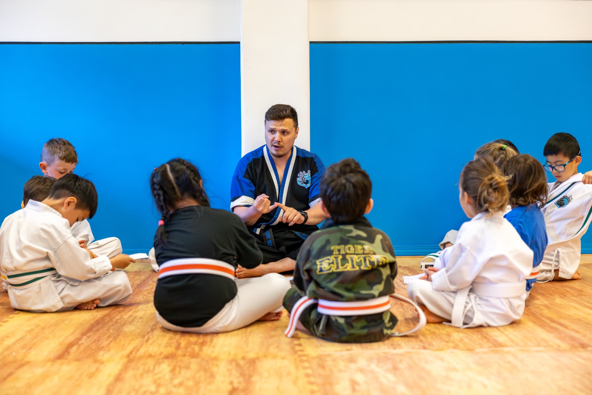 Instructor teaching a circle of Tigers students