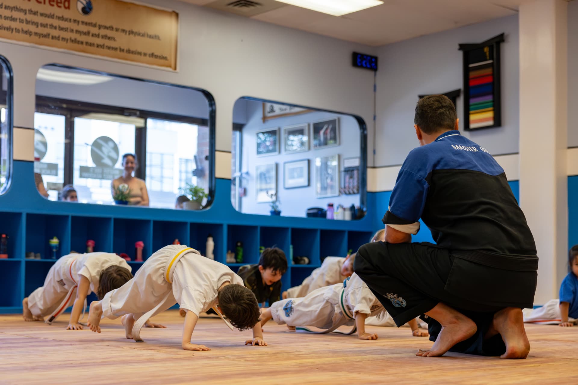 Tigers students doing push-ups with instructor