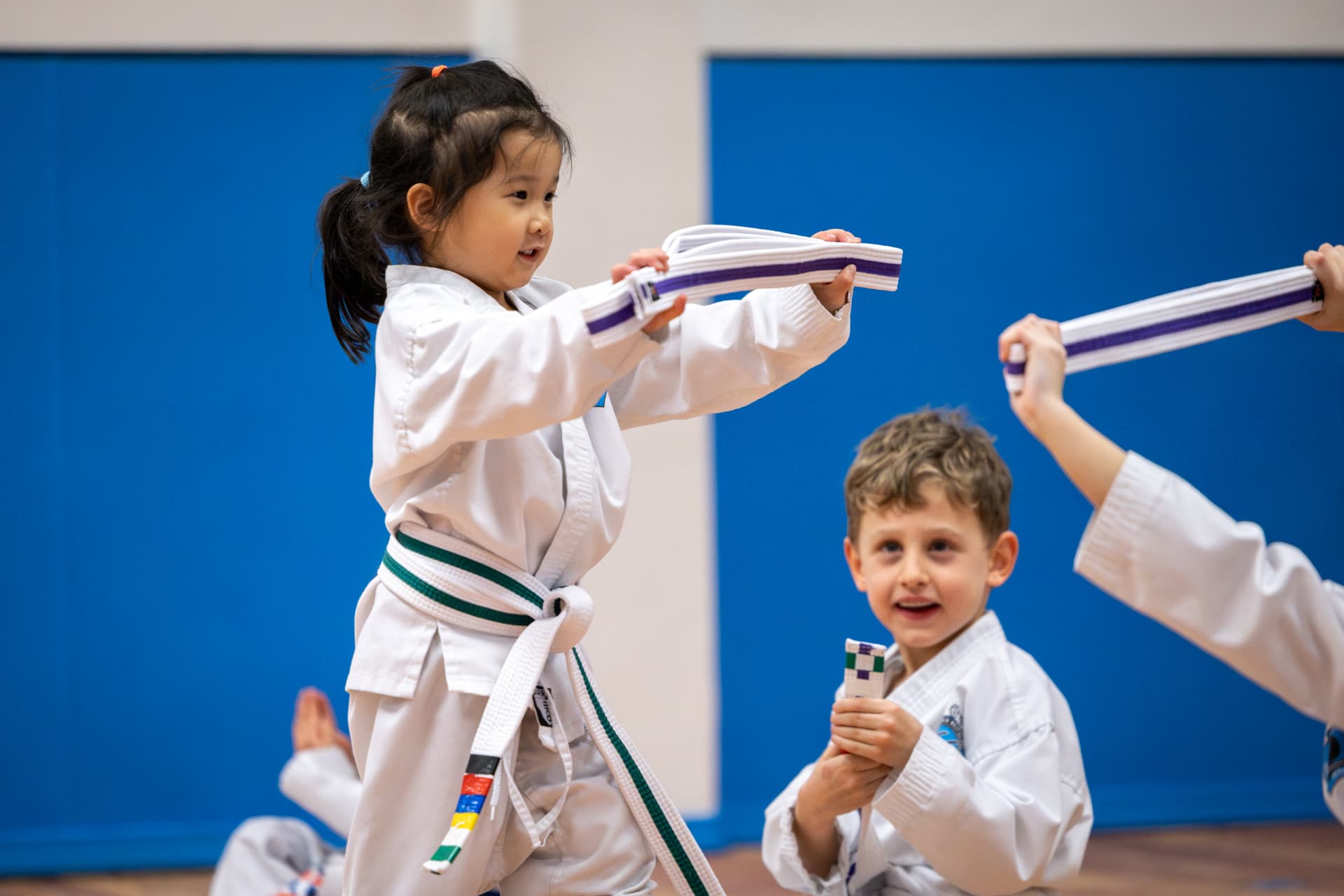 Tigers students holding up their new belts