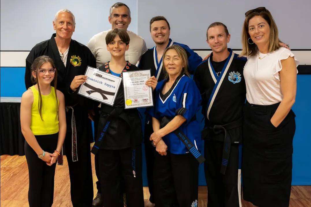 Black belt certificate presentation with family and instructors